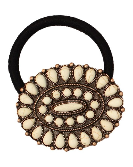 Decorative hair tie with an oval concho featuring white stones on a white background