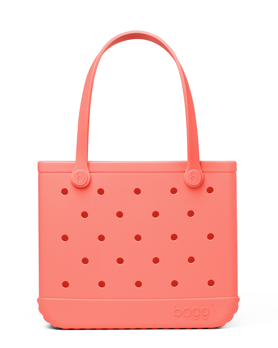Coral-colored Baby Bogg bag with perforated design on a white background