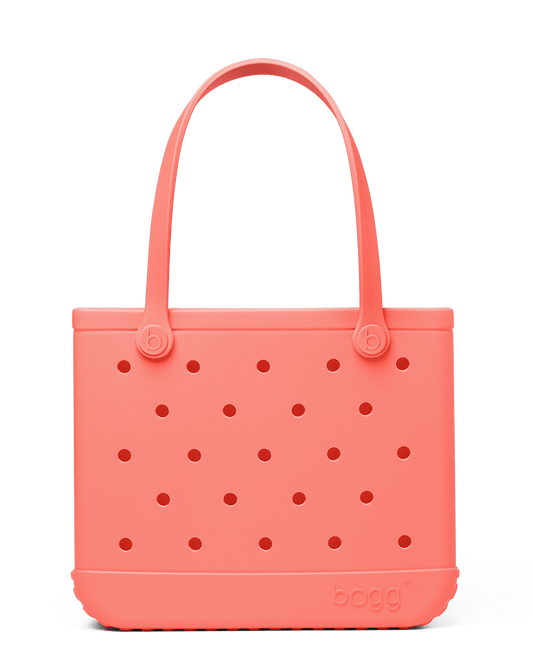 Coral-colored Baby Bogg bag with perforated design on a white background