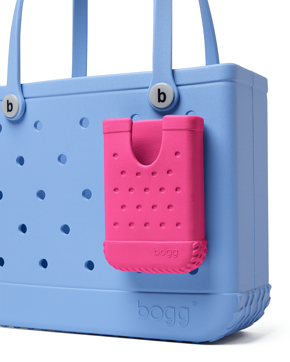 Blue Bogg bag with a pink phone holder attached on a white background