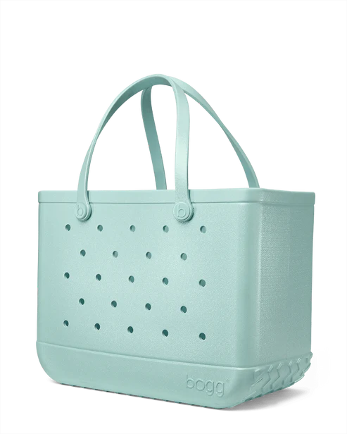 Shimmery seafoam Bogg tote bag with perforated design on a white background