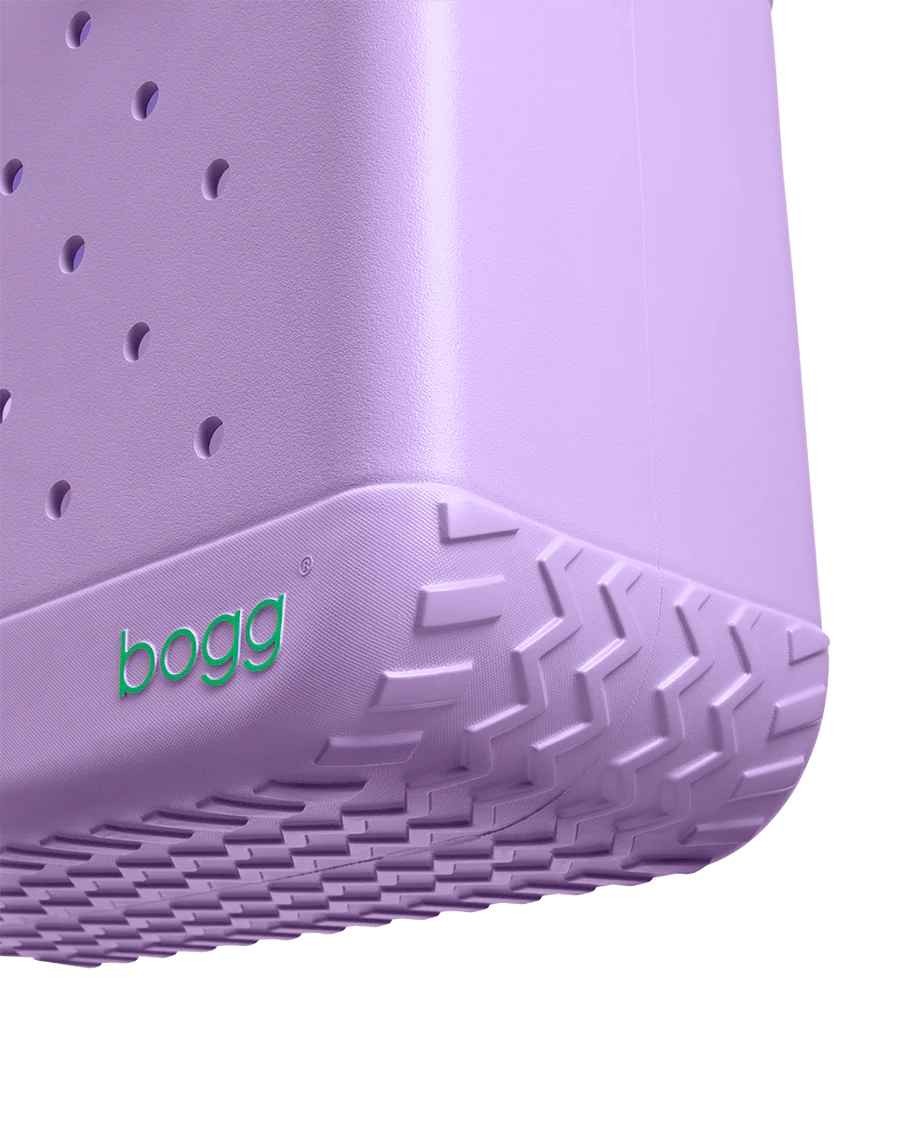 Close up of purple Bogg tote bag on a white background