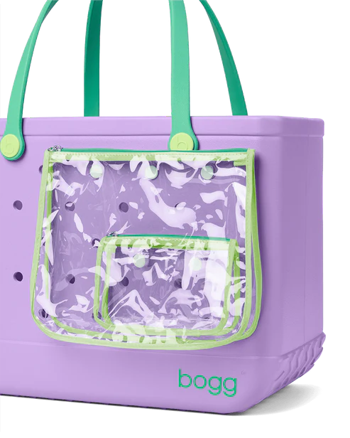 Purple tote bag with green accents and a clear front pocket, featuring the brand 'Bogg'.