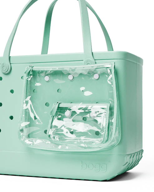 Shimmery seafoam Bogg tote bag with perforated design and clear pocket attached, on a white background