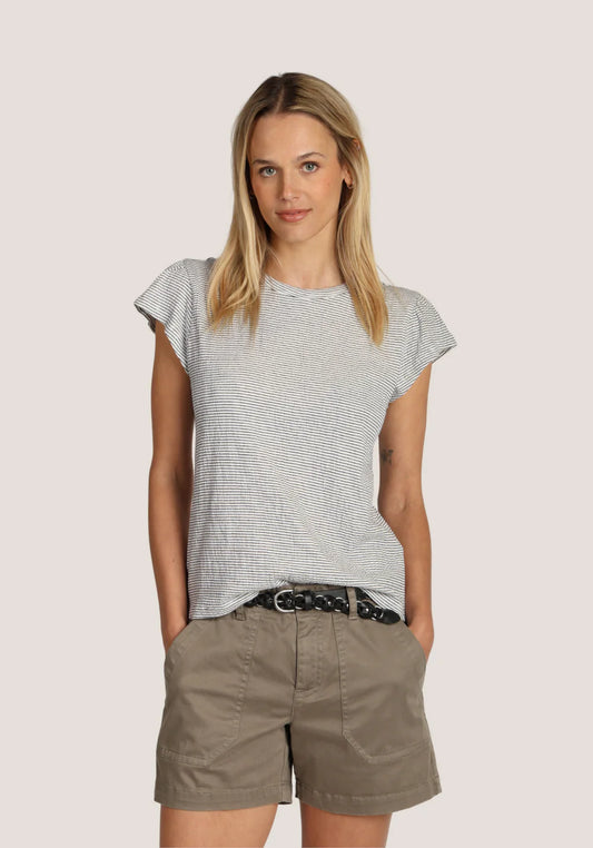 Woman wearing a striped shirt and shorts on a plain background