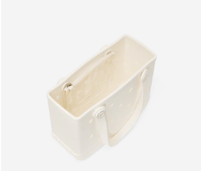 Top view of cream shimmer Bitty Bogg Bag on white background