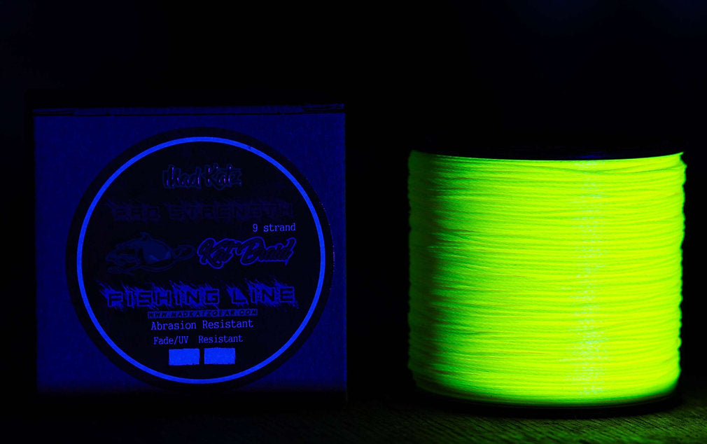 Spool of glowing green fishing line next to a label on a dark background