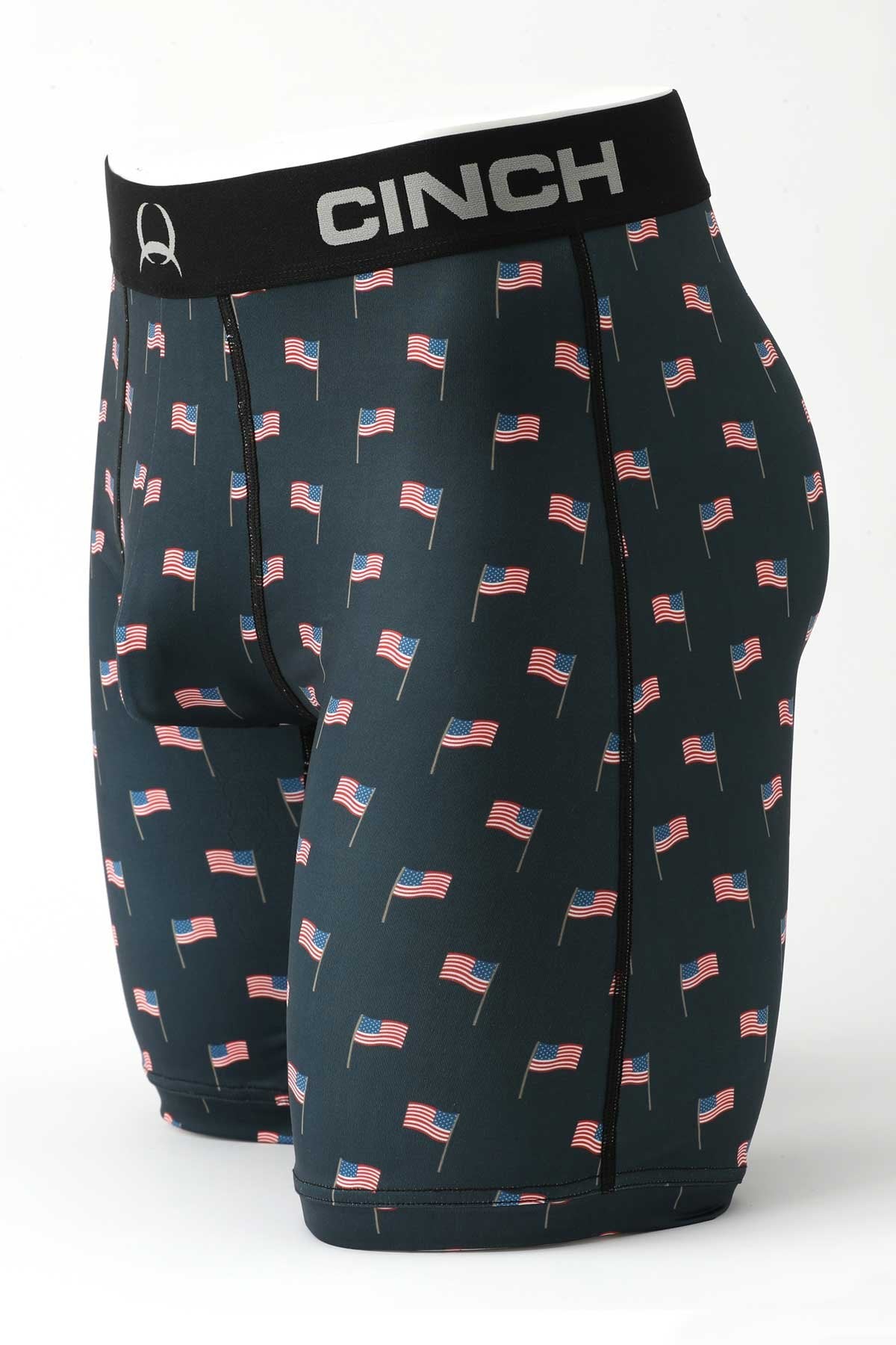 Side view of male mannequin bottom wearing navy boxer briefs with US flag print on white background