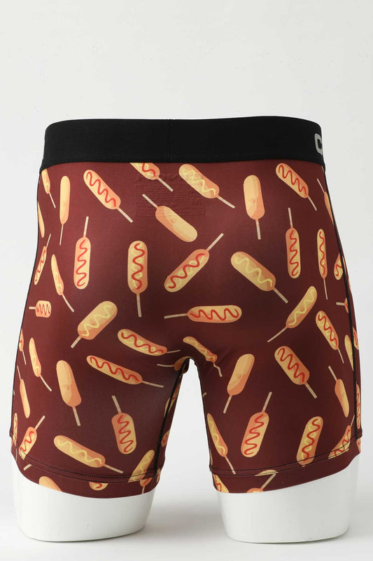 Back view of male mannequin bottom wearing burgundy boxer briefs with corndog print on white background