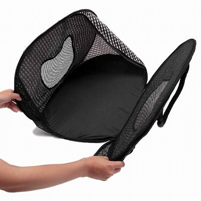 Black mesh cat carrier partially deconstructed held by a person on a white background