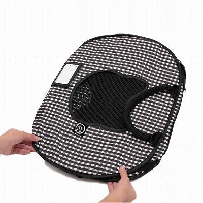 Pet carrier with checkered pattern held by a hand on a white background