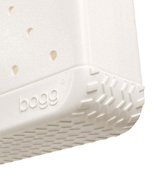 Close-up of a cream shimmer Bitty Bogg bag on a white background