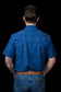 Back view of a person wearing a blue patterned Ferrell Brand shirt on a black background