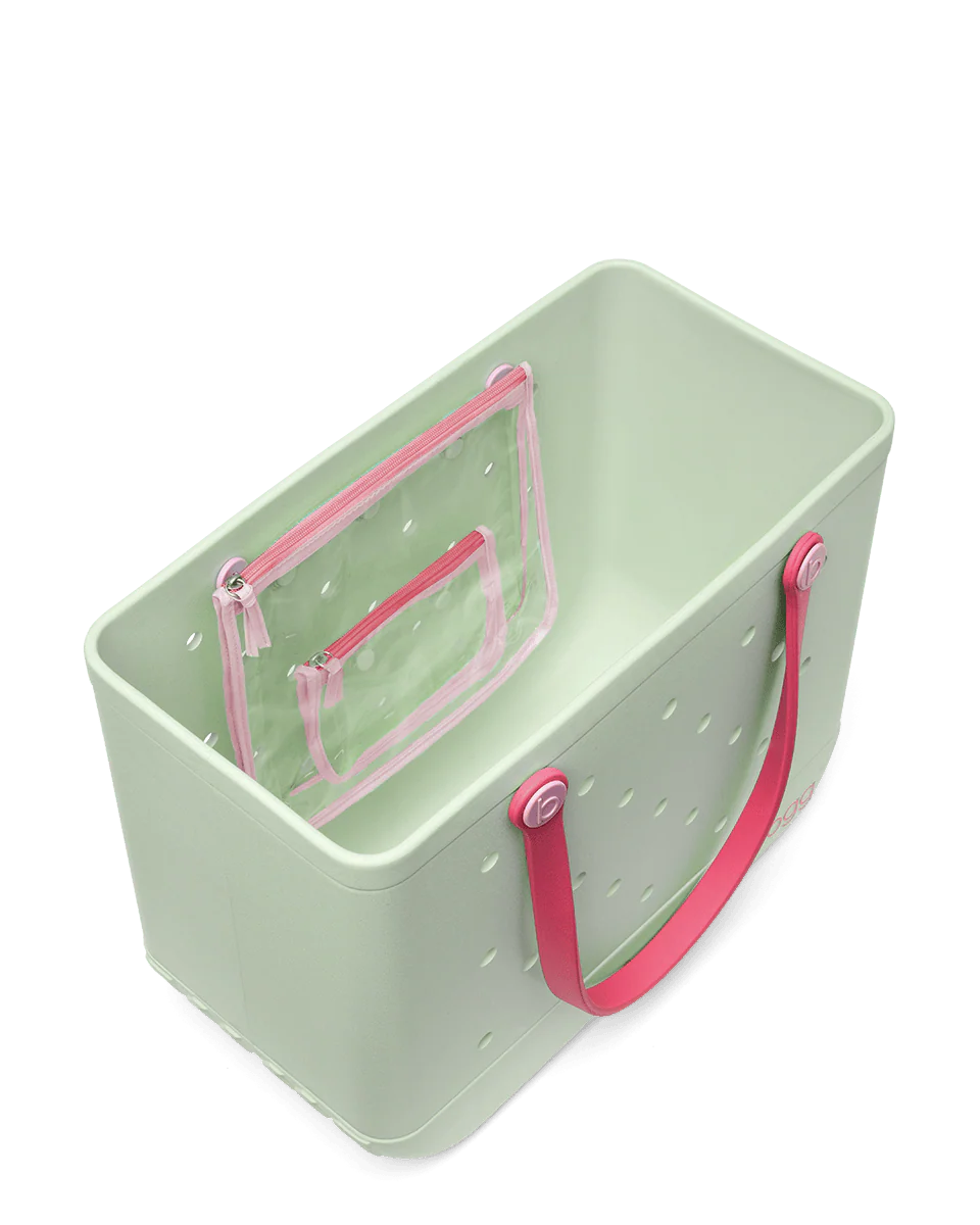 Top view of light green tote bag with pink handles on a white background