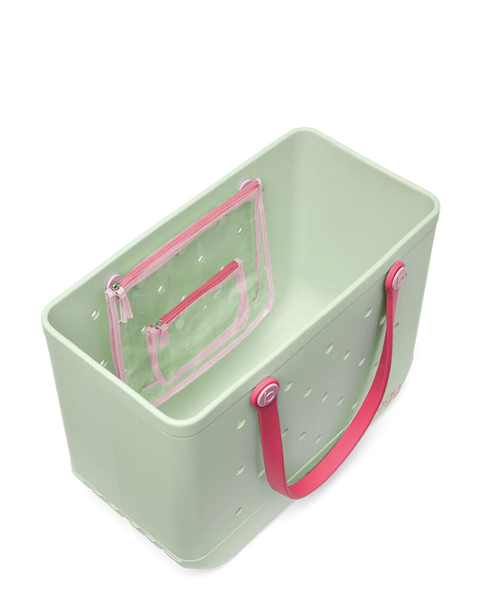 Top view of light green tote bag with pink handles on a white background