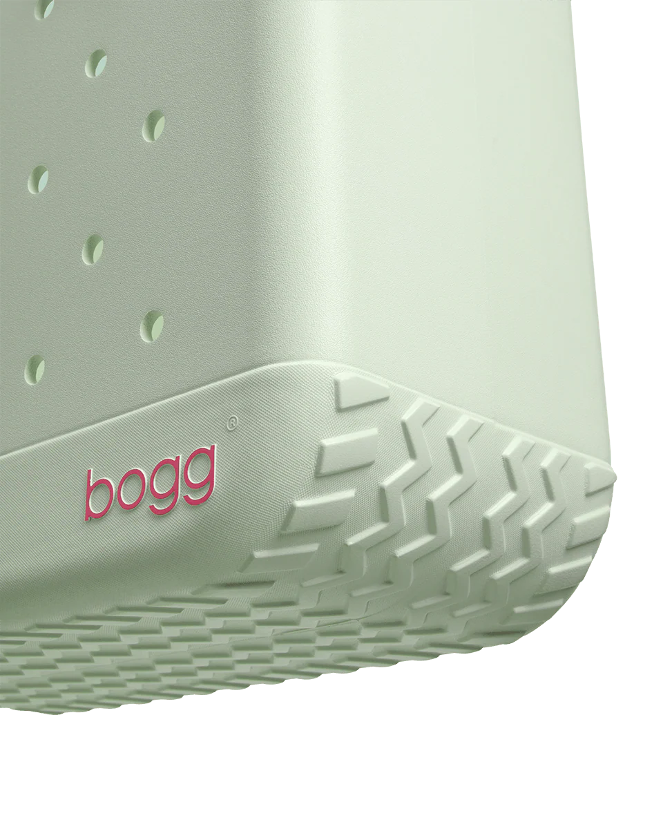 Close-up of a light green tote with 'bogg' branding on a white background