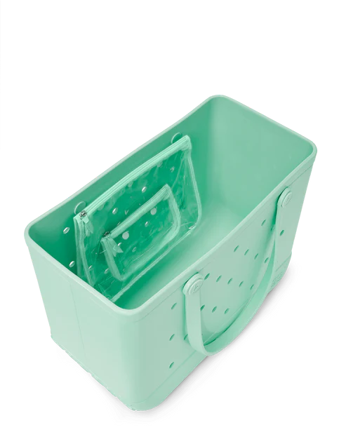 Top view of shimmery seafoam Bogg tote bag with perforated design on a white background
