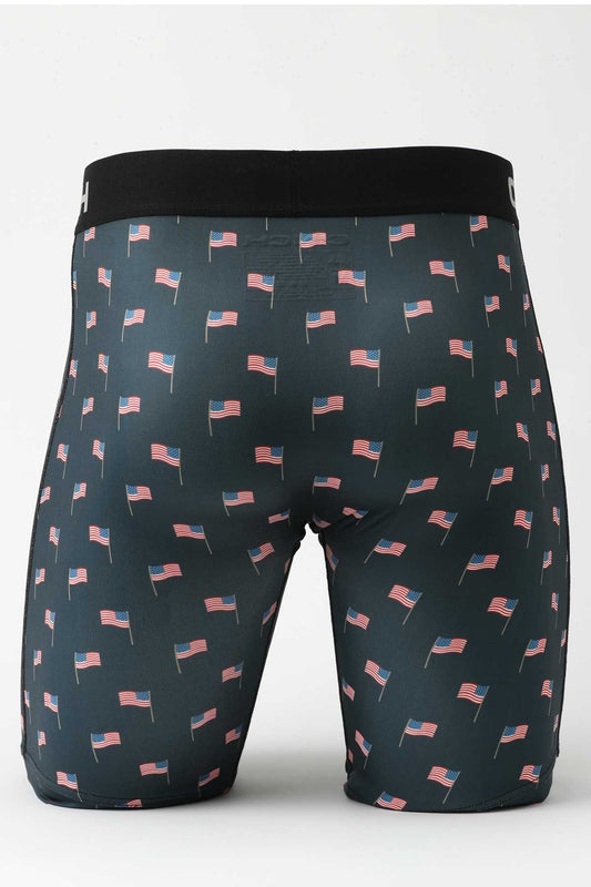 Back view of male mannequin bottom wearing navy boxer briefs with US flag print on white background