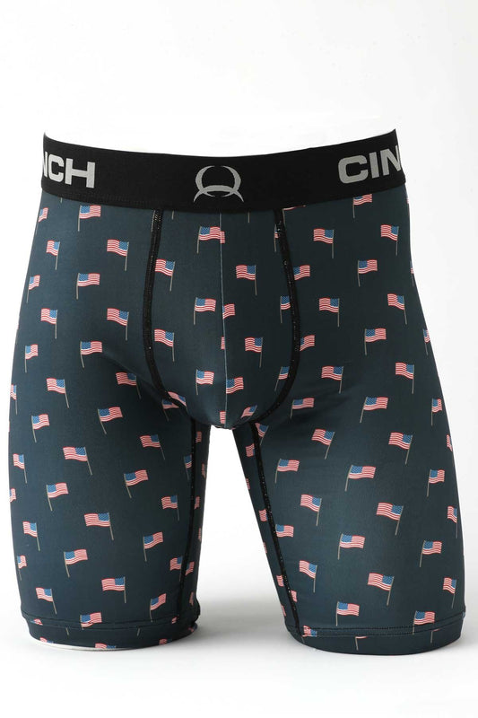Male mannequin bottom wearing navy boxer briefs with US flag print on white background