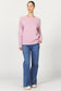 Woman wearing a pink sweatshirt and blue jeans on a white background